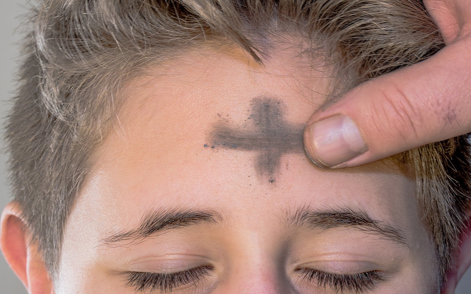 Person receiving ashes on forehead for ash wednesday