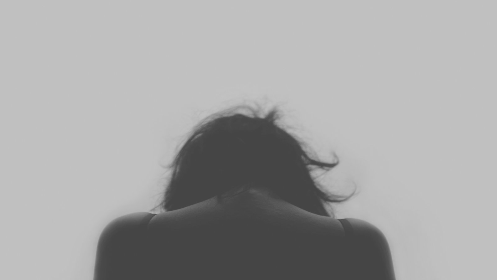 Back of woman with head looking down
